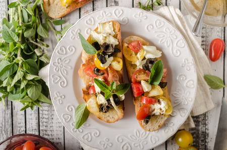 Delish simple food, roasted homemade bread with garlic and herbs, fresh vegetable and cheeseの写真素材