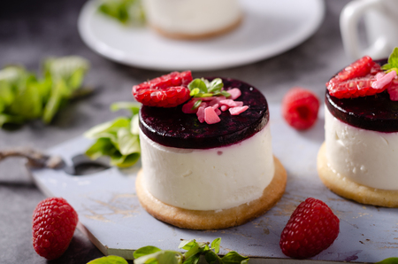 Fresh and simple dessert with fresh berries, dark chocolate cookie on top and fresh creame in middleの写真素材