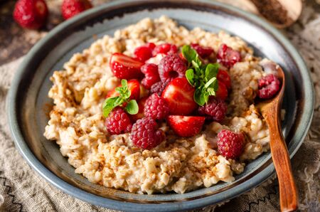 Delicious breakfast with fresh berries, cinnamon and mintの写真素材