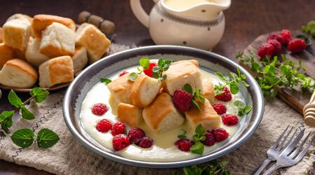 Homemade delish dessert, vanilla sauce, fresh forest fruit, original name ducat bunsの写真素材