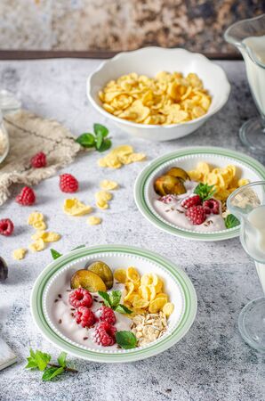 Full breakfast with lots of forest fruit, plums and yoghurtの写真素材