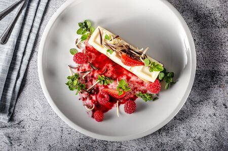 Delicious and tasty chocolate dessert with white chocolate, fresh berries and herbs on crispy...