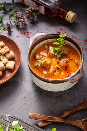 Sweet and spicy soup with crispy bread and fresh herbsの写真素材
