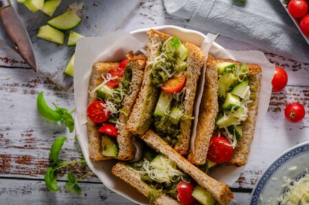 Healthy snack with tomatoes, cucumber, fresh pesto and parmesan cheeseの写真素材