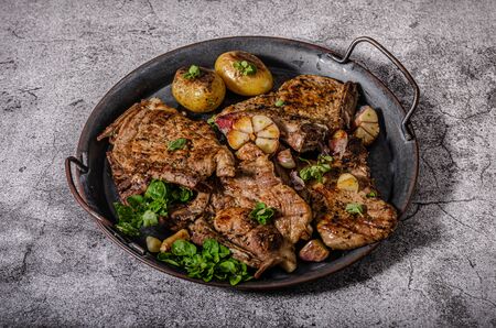 Delicious grilled meat seasoned with garlic and pepper, fresh saladの写真素材