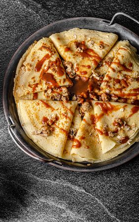 Baked granola with delicious caramel sauce and fresh crepes