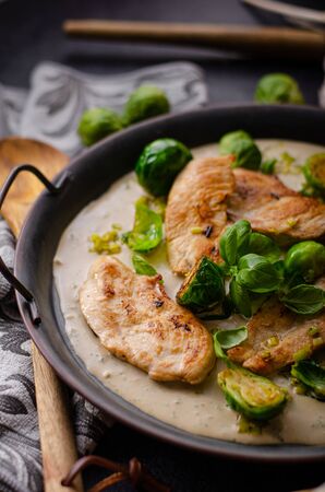 Grilled chicken with garlic cream, delicious brussels sproutの写真素材