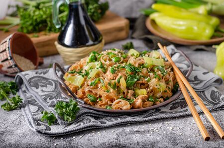 Crispy noodles with roasted chicken, fresh vegetable and soy sauceの写真素材