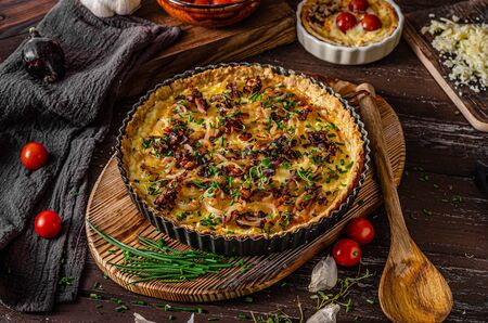 Delicious rustic quiche with roasted onion and crispy baconの写真素材