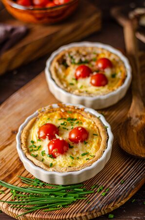 Rustic cheese quiche with bio cocktail tomatoesの写真素材