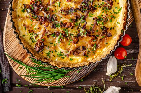 Delicious rustic quiche with roasted onion and crispy baconの写真素材
