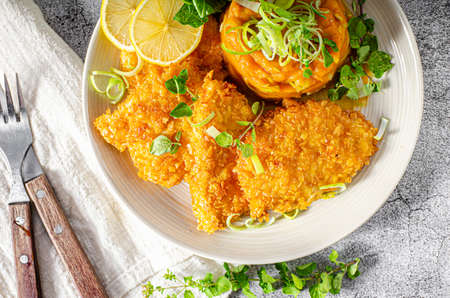 Delicious breaded meat with cornflakes and sweet potatoes