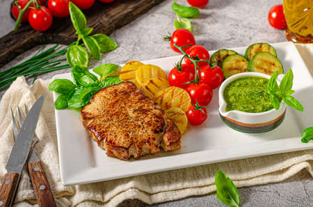 Grilled steak with herbs sauce, grilled vegetable with garlicの写真素材