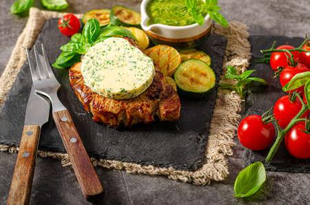 Grilled steak with herbs butter, grilled vegetable with garlicの写真素材