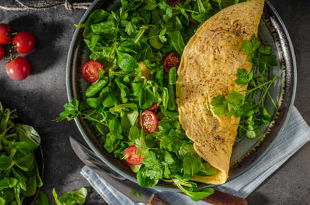 Fresh and tasty omelette with salad and mini tomatoes