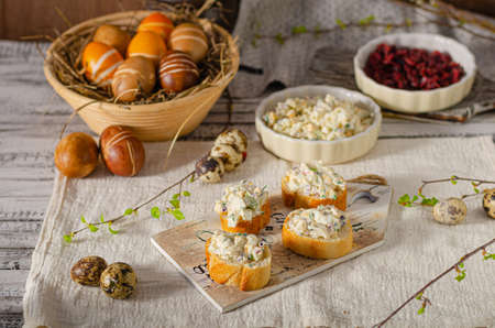 Delicious egg spread on fresh baquette with easter decorationの写真素材