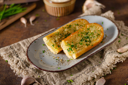 Delicious baguette with butter, parmesan cheese and garlicの写真素材