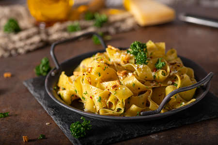Delicious organic pappardelle with roasted garlic and chilli flakesの写真素材