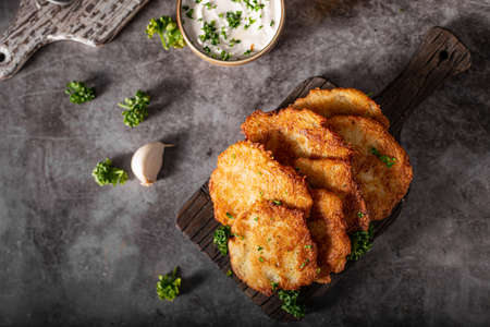 Homemade potato latkes with garlic sour creame and fresh herbs