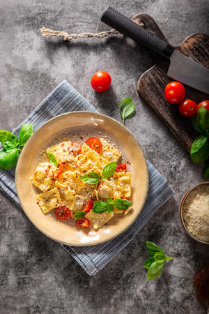 Homemade pasta with parmesan, chilli and fresch cheese insideの写真素材
