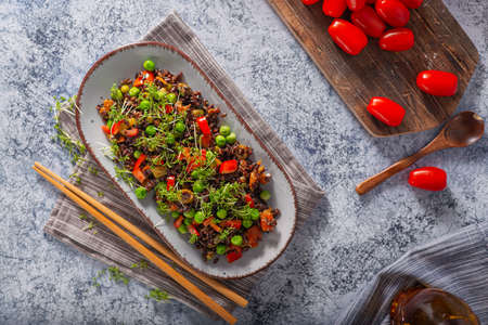 Delicious and organic black rice salad with microgreensの写真素材