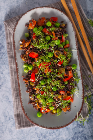 Delicious and organic black rice salad with microgreensの写真素材