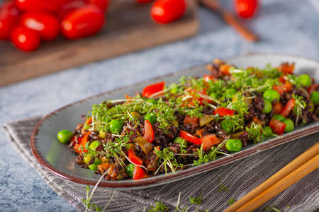 Delicious and organic black rice salad with microgreensの写真素材