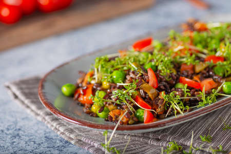 Delicious and organic black rice salad with microgreensの写真素材