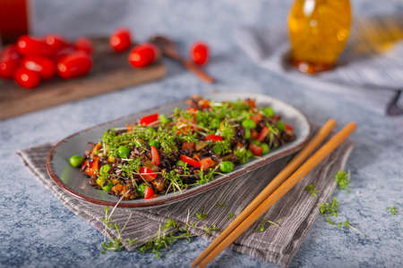 Delicious and organic black rice salad with microgreensの写真素材