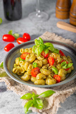 Basil pesto with homemade pasta, roasted tomatoes and parmesanの写真素材