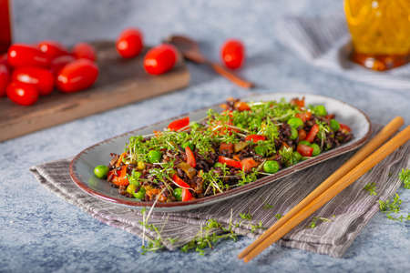 Delicious and organic black rice salad with microgreensの写真素材