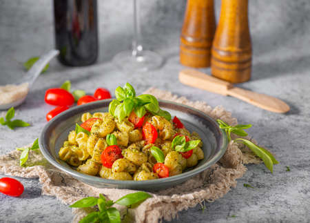 Basil pesto with homemade pasta, roasted tomatoes and parmesanの写真素材
