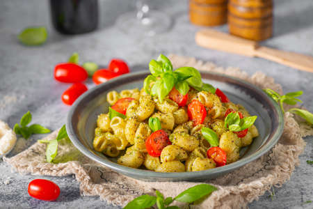 Basil pesto with homemade pasta, roasted tomatoes and parmesanの写真素材