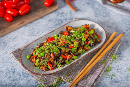 Delicious and organic black rice salad with microgreensの写真素材