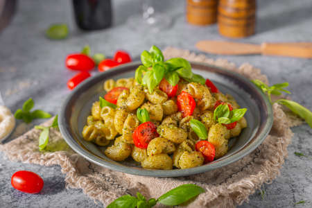Basil pesto with homemade pasta, roasted tomatoes and parmesanの写真素材