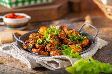Roasted mushrooms and chilli sauce topped with herbsの写真素材