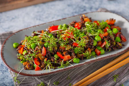 Delicious and organic black rice salad with microgreensの写真素材