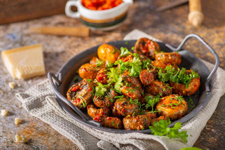 Roasted mushrooms and chilli sauce topped with herbsの写真素材