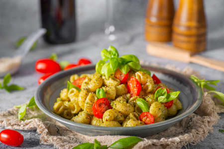 Basil pesto with homemade pasta, roasted tomatoes and parmesanの写真素材