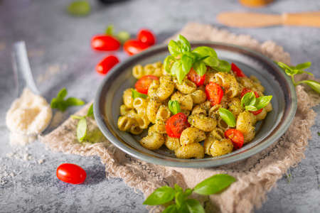 Basil pesto with homemade pasta, roasted tomatoes and parmesanの写真素材