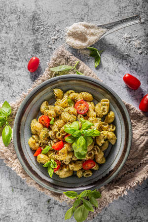 Basil pesto with homemade pasta, roasted tomatoes and parmesanの写真素材