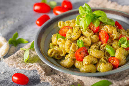 Basil pesto with homemade pasta, roasted tomatoes and parmesanの写真素材