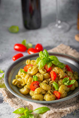 Basil pesto with homemade pasta, roasted tomatoes and parmesanの写真素材