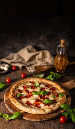 Delicous pizza with hot salami, parmesan and fresh basilの写真素材