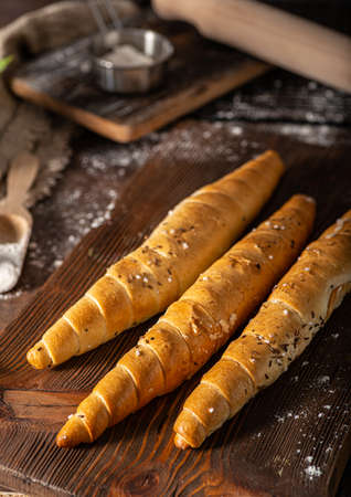 Homemade roll with seeds, garlic and basilの写真素材