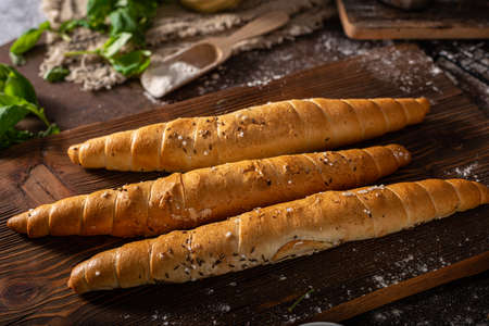 Homemade roll with seeds, garlic and basilの写真素材