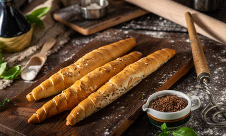 Homemade roll with seeds, garlic and basilの写真素材