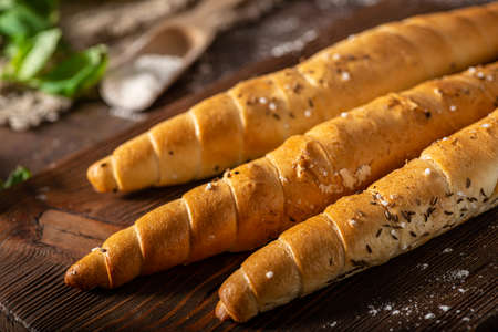 Homemade roll with seeds, garlic and basilの写真素材