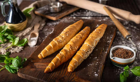 Homemade roll with seeds, garlic and basilの写真素材