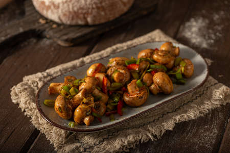 Mushroom salad with chilli, peppers and herbsの写真素材